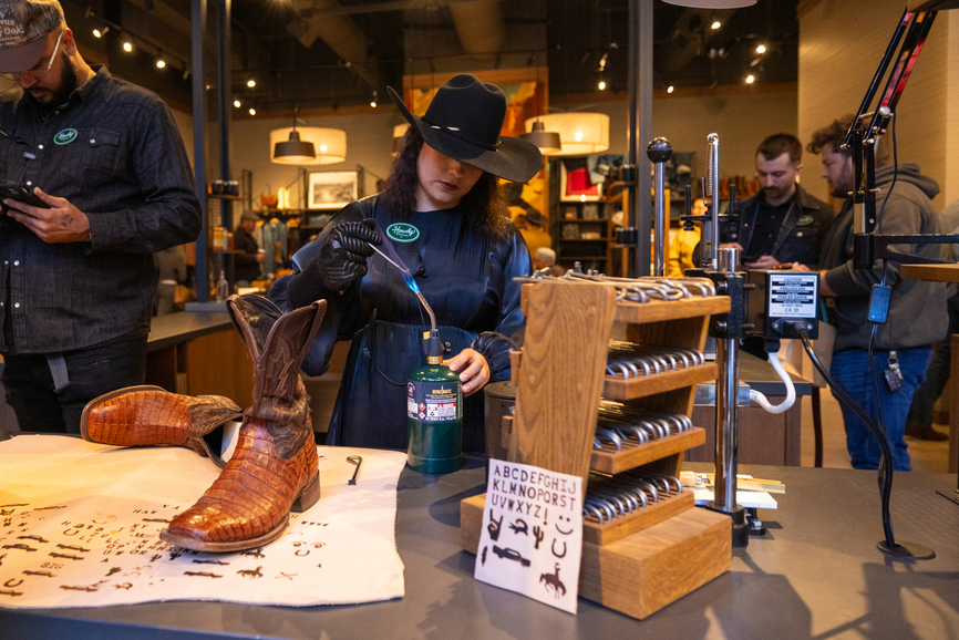 A photograph of a customer browsing merchandise at Tecovas Detroit.