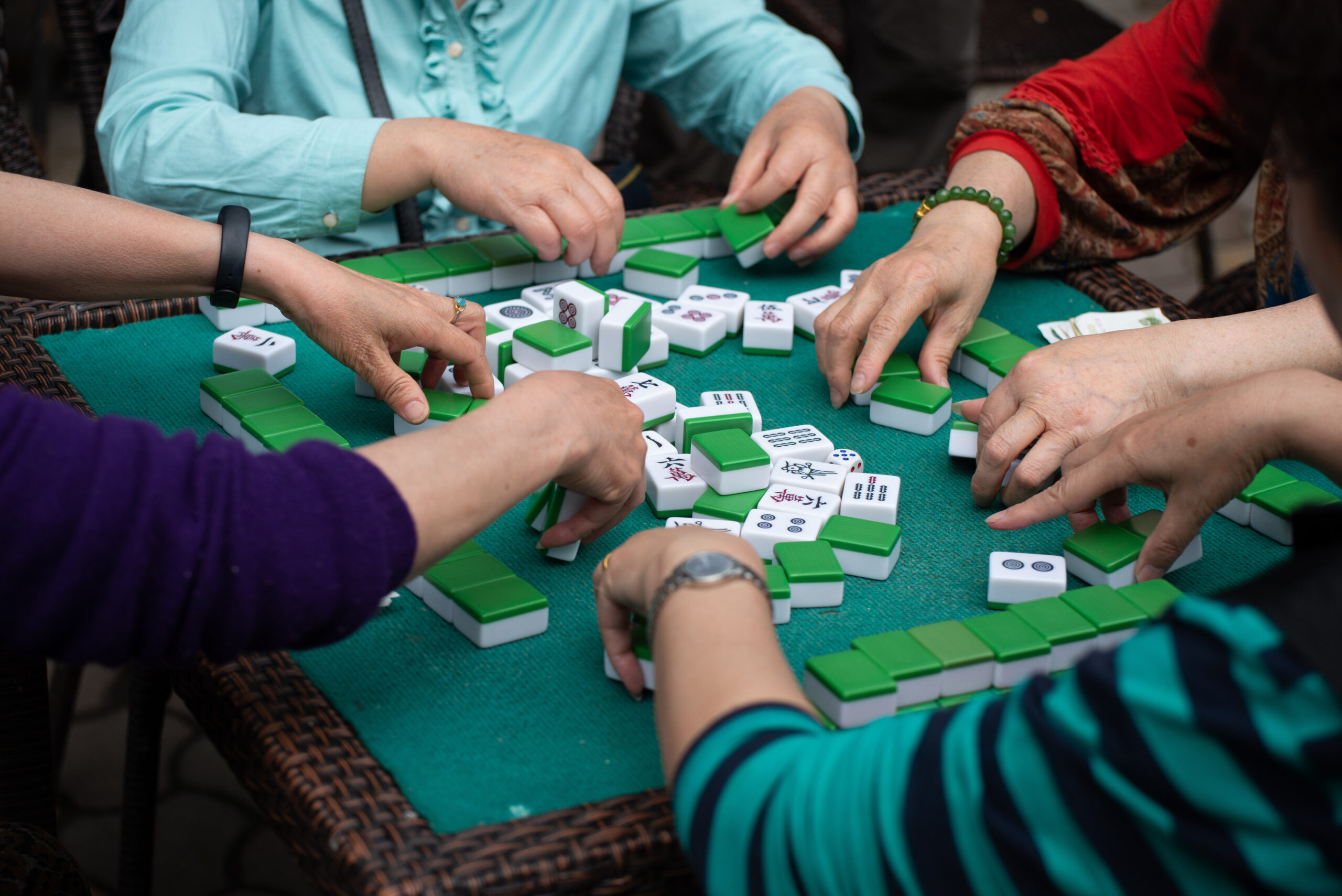 Stock photo of people playing mahjong.